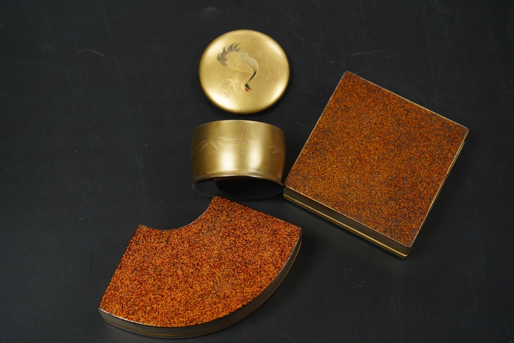 Three Japanese gilt lacquer boxes, one depicting Mount Fuji, largest 9cm wide